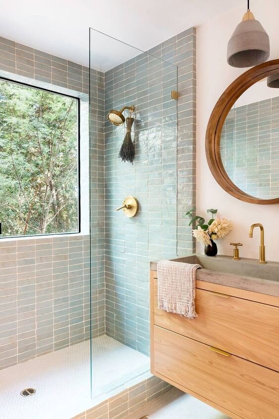 Frameless glass shower screen with gold hardware